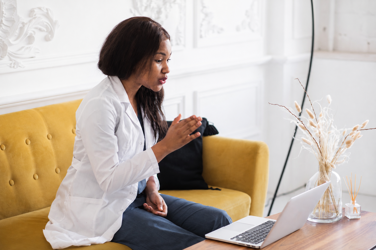 Healthcare professional practicing interview answers on a laptop